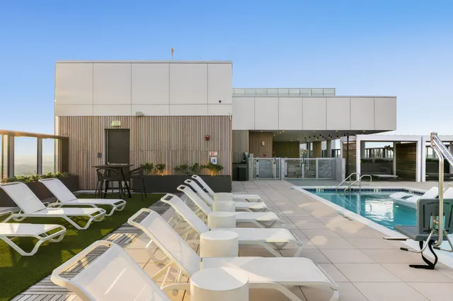 a swimming pool with outdoor seating and yard