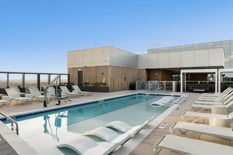 a living room with furniture and floor to ceiling window