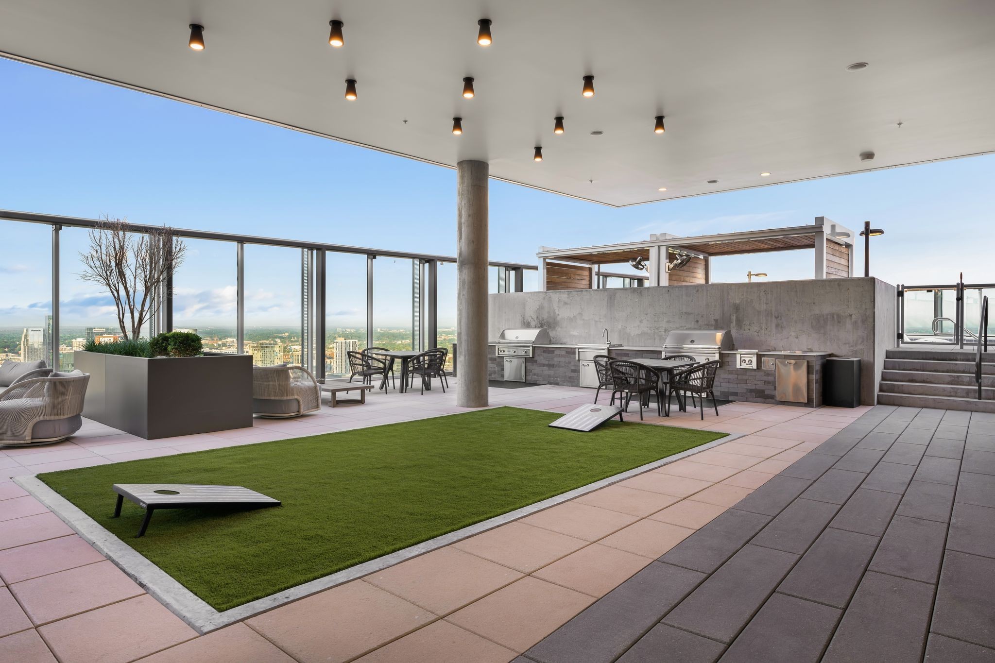 1616 West End Avenue, Unit 2609 Nashville, TN 37203 - Photo 27 of 46 a view of a patio with dining table and chairs with plants and wooden floor