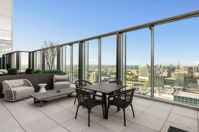 a view of a bathroom with furniture and large windows