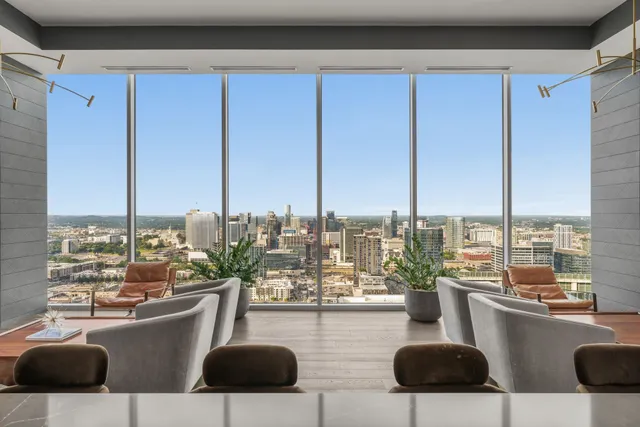 a living room with furniture and a chandelier