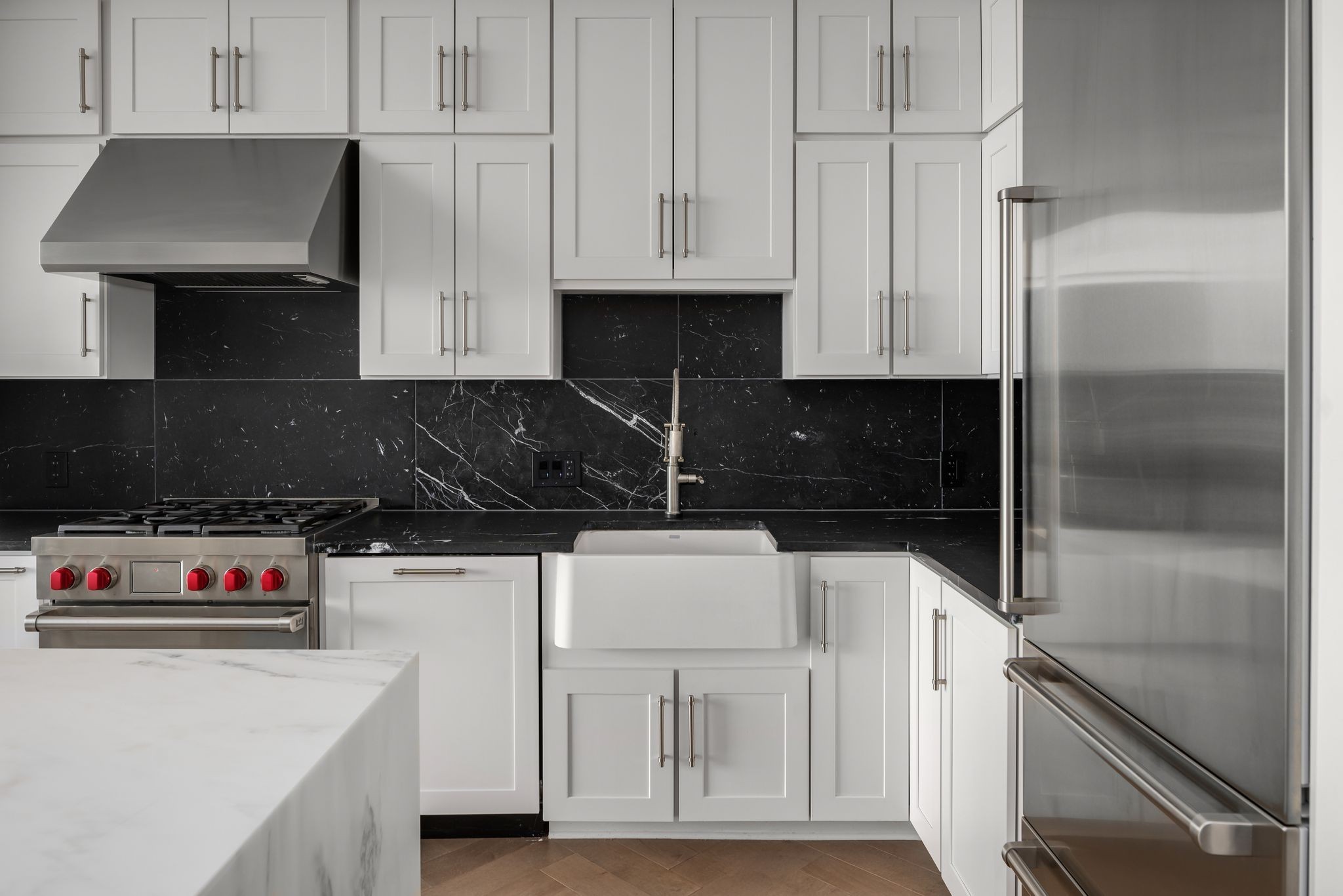 1616 West End Avenue, Unit 2609 Nashville, TN 37203 - Photo 5 of 46 a kitchen with white cabinets and black appliances