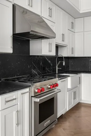 a kitchen with granite countertop a stove and a microwave