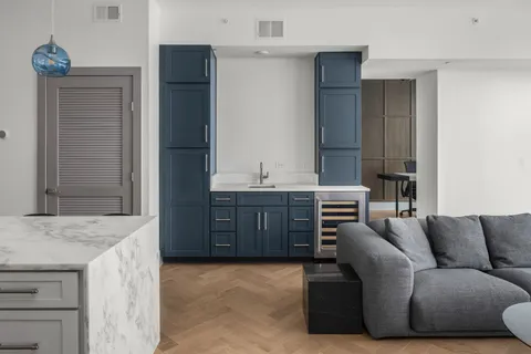 a living room with furniture and a dresser