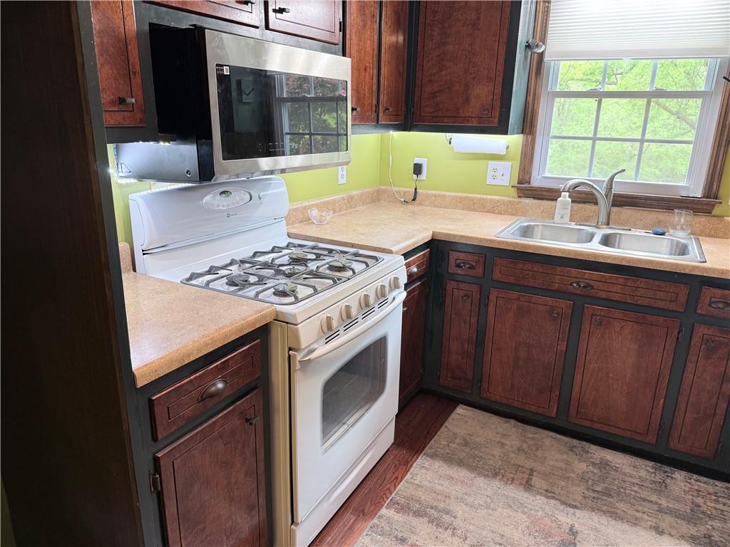 3033 Riviera Drive Conyers, GA 30012 - Photo 12 of 79 a kitchen with a sink stove and cabinets