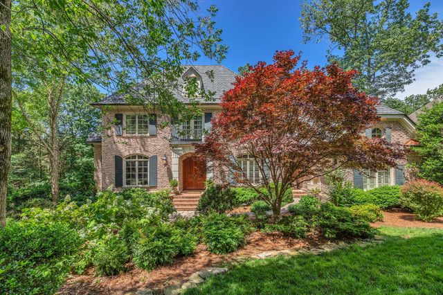 front view of a house with a tree