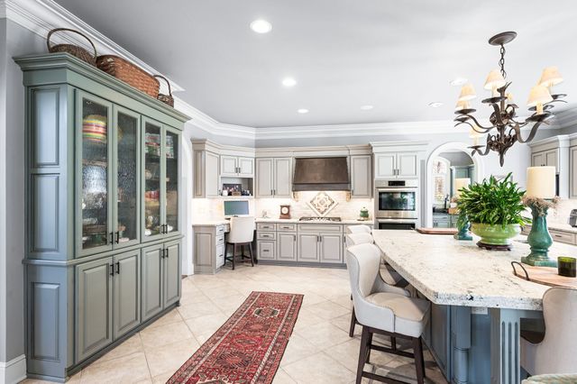 a view of a house with a big yard and large trees