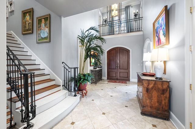 a kitchen with a table chairs refrigerator and cabinets