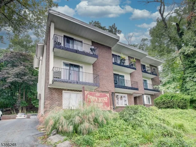 a front view of a building with a garden