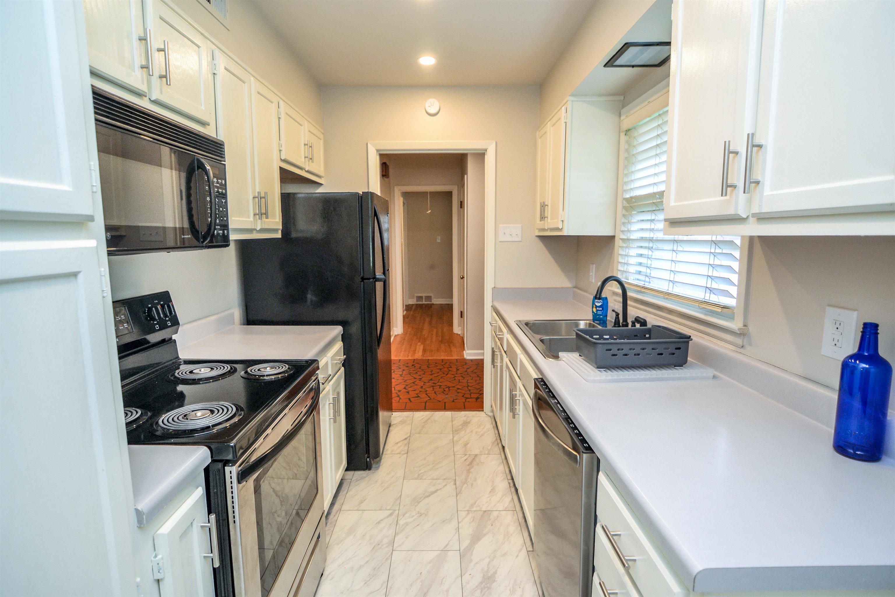 5200 Rich Road Memphis, TN 38117 - Photo 6 of 26 a kitchen with stainless steel appliances granite countertop a sink stove and refrigerator