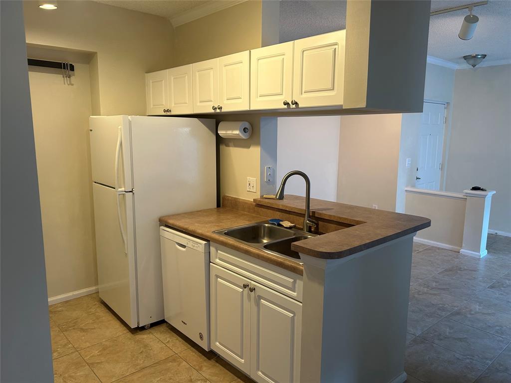 17150 North Bay Road, Unit 2519 Sunny Isles Beach, FL 33160 - Photo 4 of 9 a kitchen with stainless steel appliances granite countertop a sink and a refrigerator