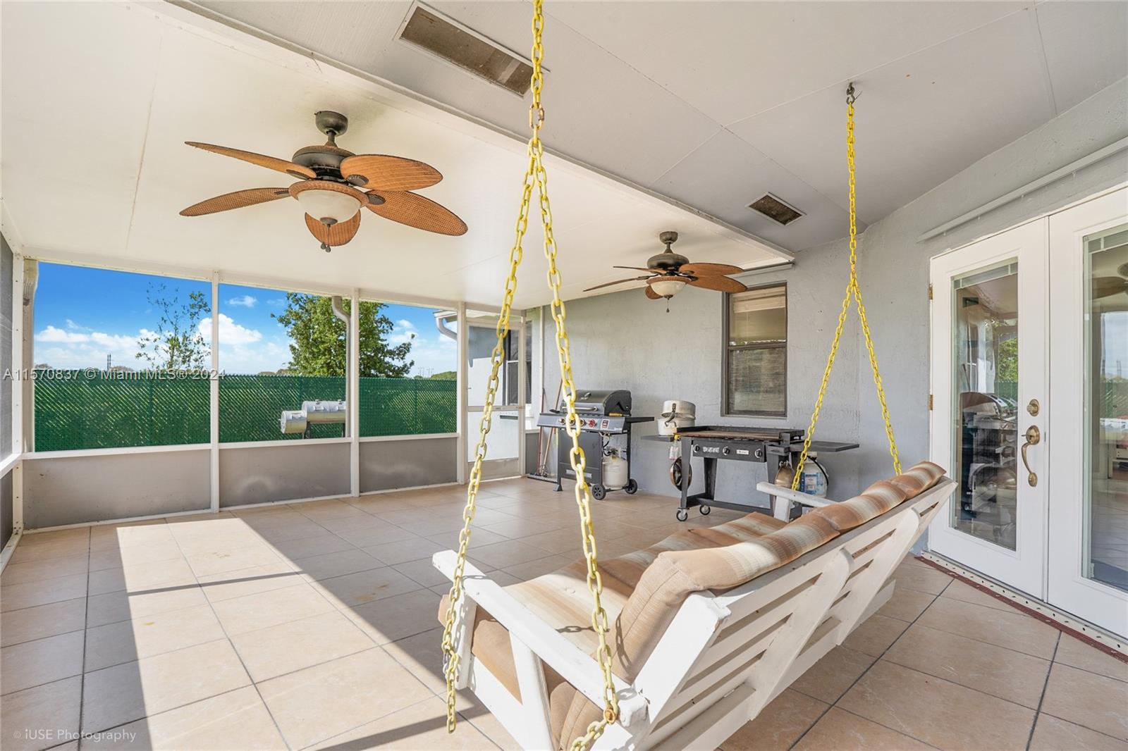 15440 Gauntlet Hall Manor Davie, FL 33331 - Photo 4 of 18 a living room with patio furniture and a floor to ceiling window