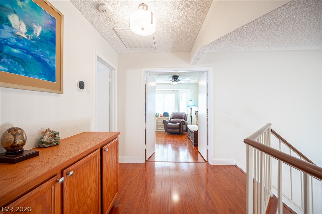 718 Rusty Spur Drive Henderson, NV 89014 - Photo 38 of 50 Lustrous hardwood floors guide you into a cozy den with natural light.