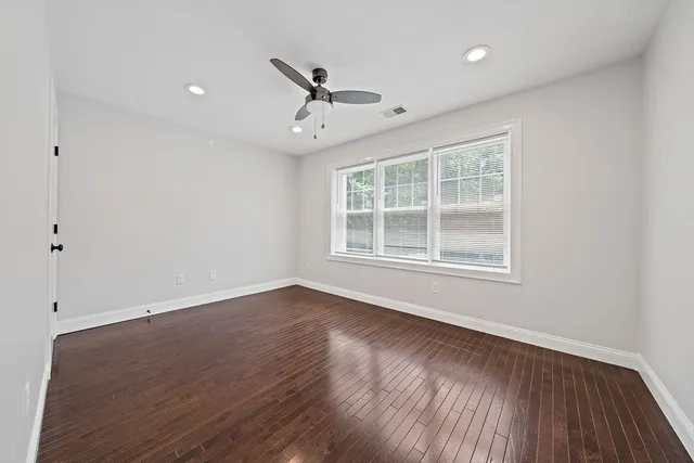 wooden floor in an empty room with a window