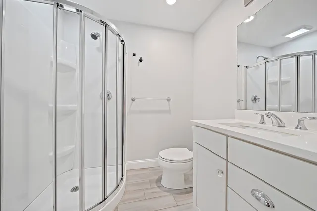 a bathroom with a toilet sink and shower