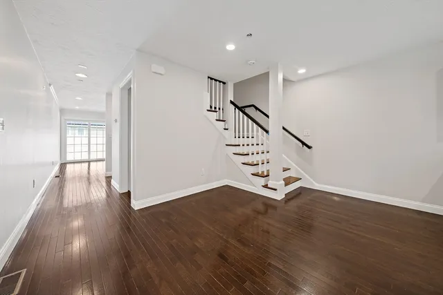 a view of an entryway with wooden floor