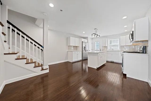 a view of kitchen with wooden floor and electronic appliances