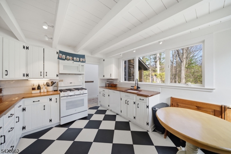 109 Taylortown Road Montville, NJ 07005 - Photo 11 of 50 a kitchen with a sink a stove a window and cabinets