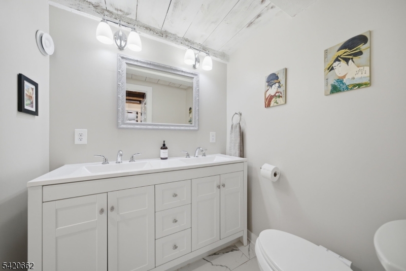 109 Taylortown Road Montville, NJ 07005 - Photo 25 of 50 a bathroom with a toilet sink and mirror