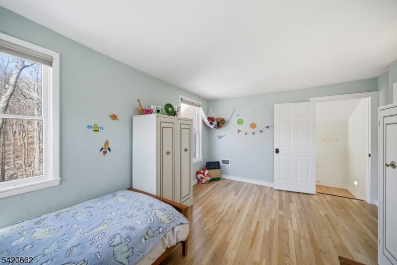 109 Taylortown Road Montville, NJ 07005 - Photo 37 of 50 a bedroom with a bed and wooden floor