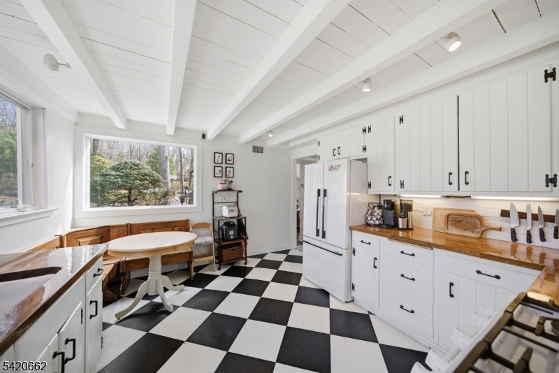 109 Taylortown Road Montville, NJ 07005 - Photo 9 of 50 a room with a black white checkered floor with a gaming machine and appliances