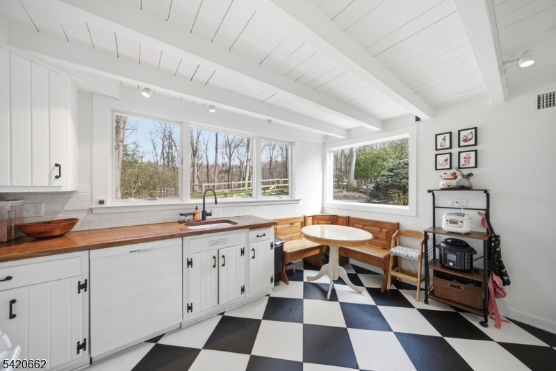 109 Taylortown Road Montville, NJ 07005 - Photo 10 of 50 a room with a black white checkered floor with a sink and white cabinets
