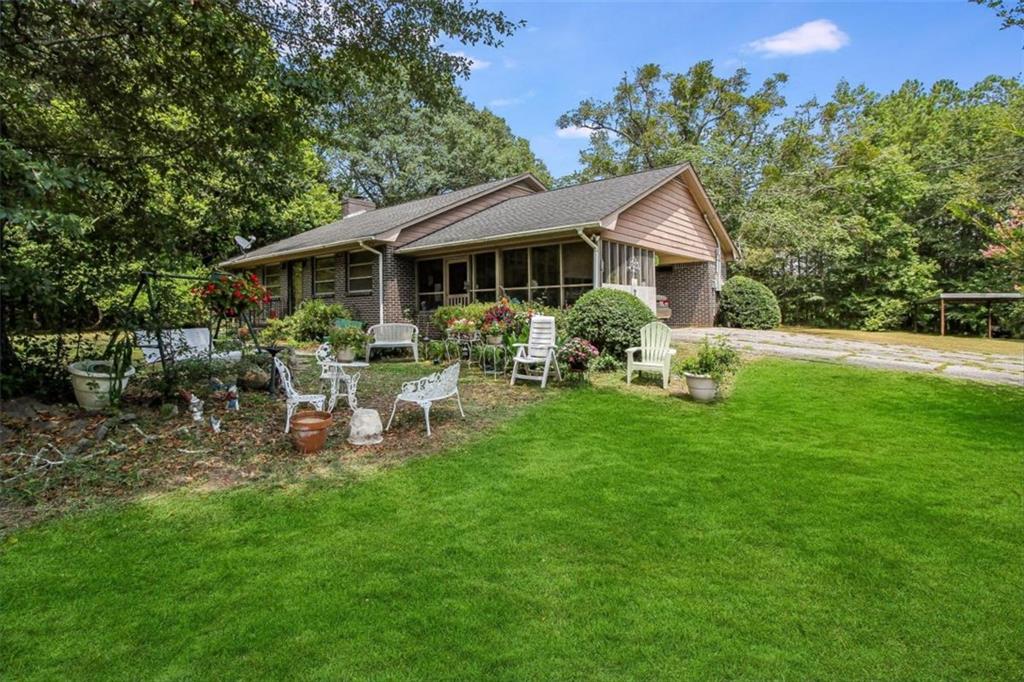 a front view of a house with garden and porch