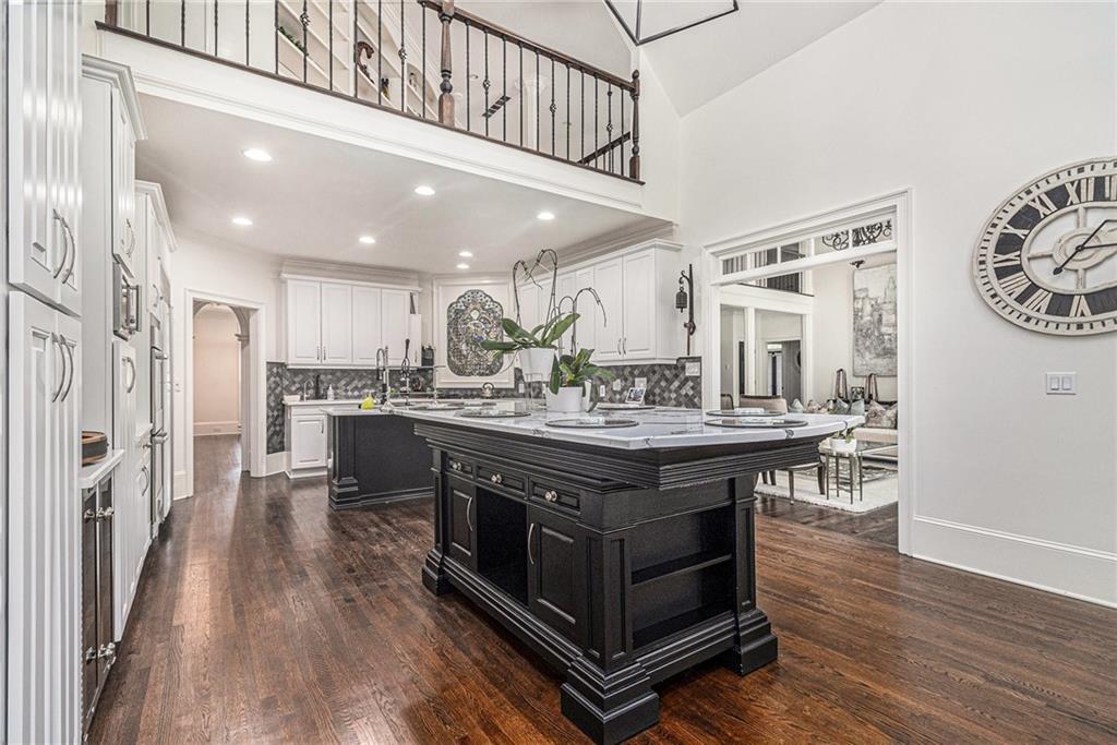 240 Wicklawn Way Roswell, GA 30076 - Photo 15 of 62 a kitchen with stainless steel appliances granite countertop a table chairs stove and cabinets