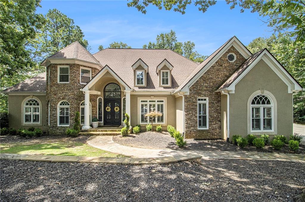 240 Wicklawn Way Roswell, GA 30076 - Photo 2 of 62 a front view of a house with a yard