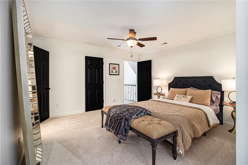 240 Wicklawn Way Roswell, GA 30076 - Photo 43 of 62 a bedroom with a bed and a chandelier