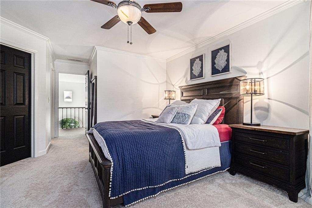 240 Wicklawn Way Roswell, GA 30076 - Photo 44 of 62 a bedroom with a bed and a chandelier