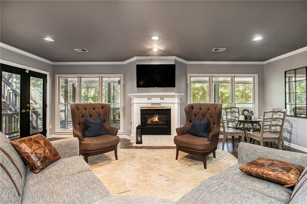 240 Wicklawn Way Roswell, GA 30076 - Photo 46 of 62 a living room with furniture flat screen tv and a fireplace