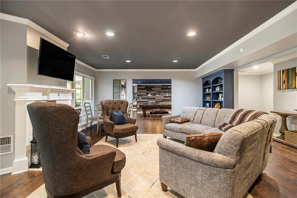 240 Wicklawn Way Roswell, GA 30076 - Photo 48 of 62 a living room with furniture a flat screen tv and a fireplace