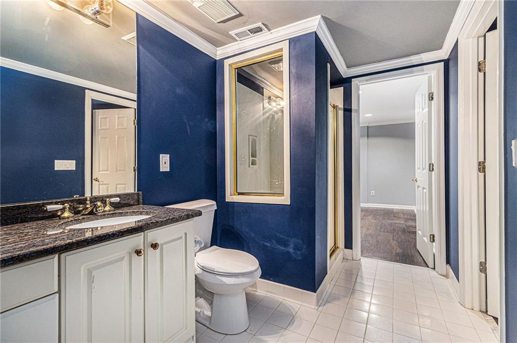 240 Wicklawn Way Roswell, GA 30076 - Photo 56 of 62 a bathroom with a granite countertop sink toilet and shower