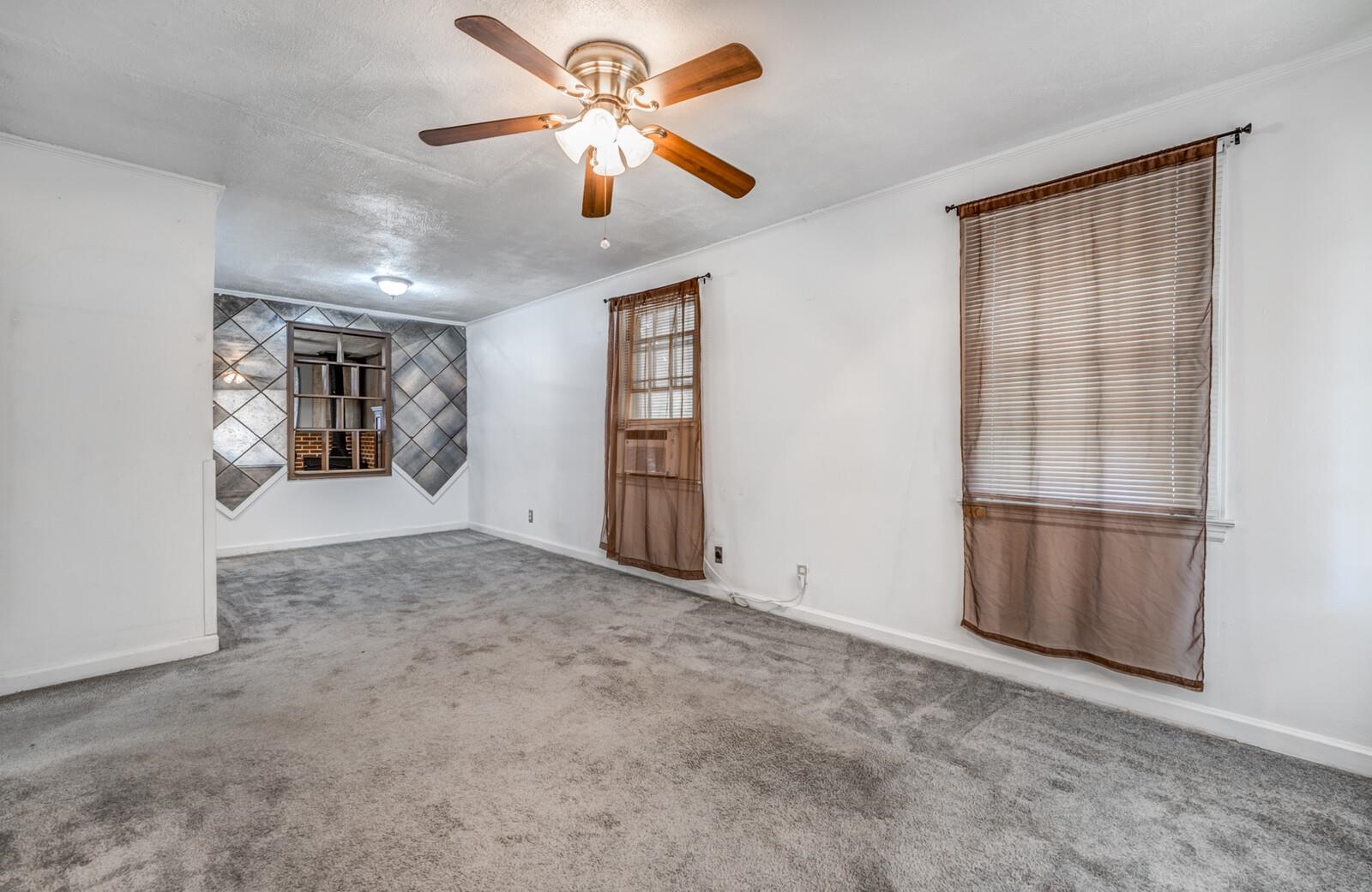 4621 Macon Road Memphis, TN 38122 - Photo 4 of 40 an empty room with windows and ceiling fan