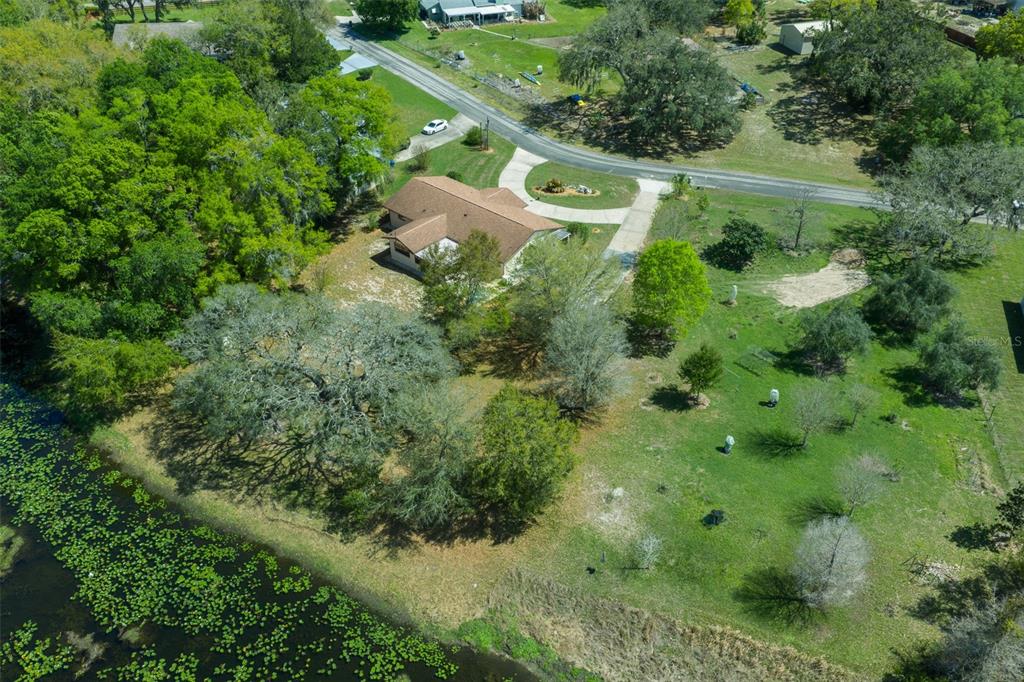 9923 East St Regis Court Inverness, FL 34450 - Photo 11 of 76 an aerial view of residential house with outdoor space and trees all around