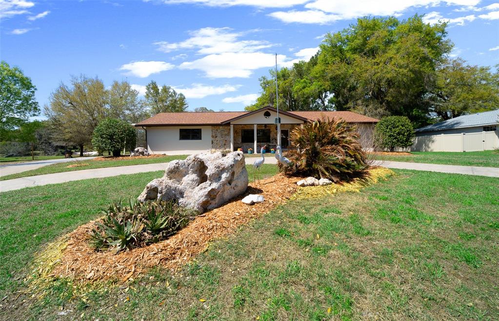 9923 East St Regis Court Inverness, FL 34450 - Photo 16 of 76 a view of a house with backyard and garden