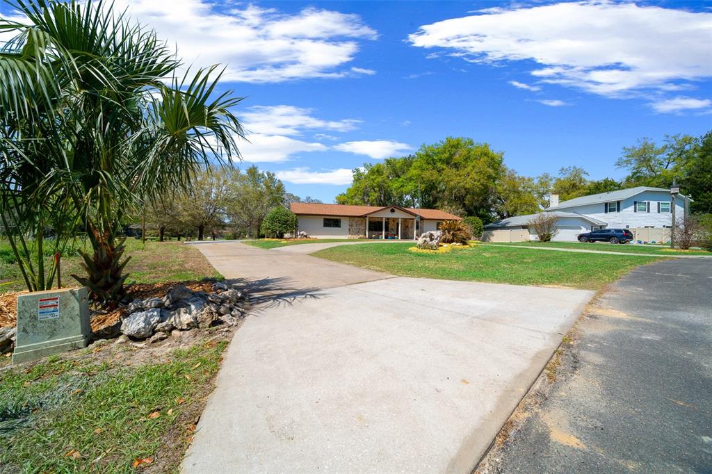 9923 East St Regis Court Inverness, FL 34450 - Photo 19 of 76 a view of a street with a building in the background
