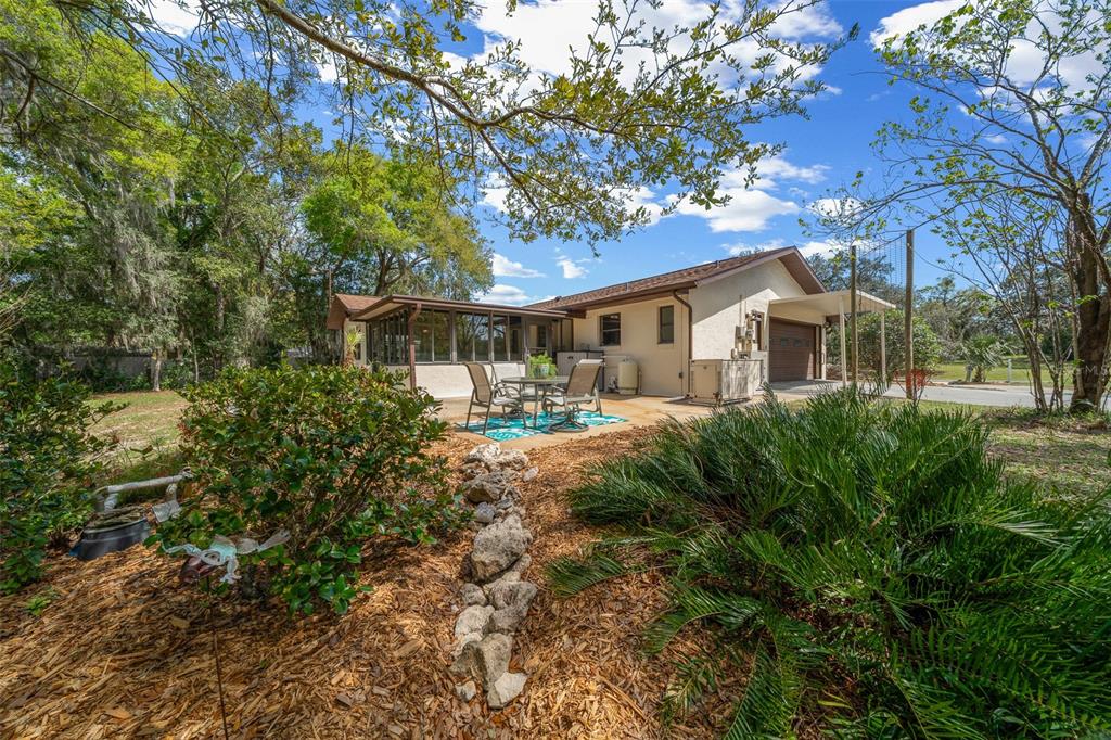9923 East St Regis Court Inverness, FL 34450 - Photo 21 of 76 a view of a yard with plants and large trees