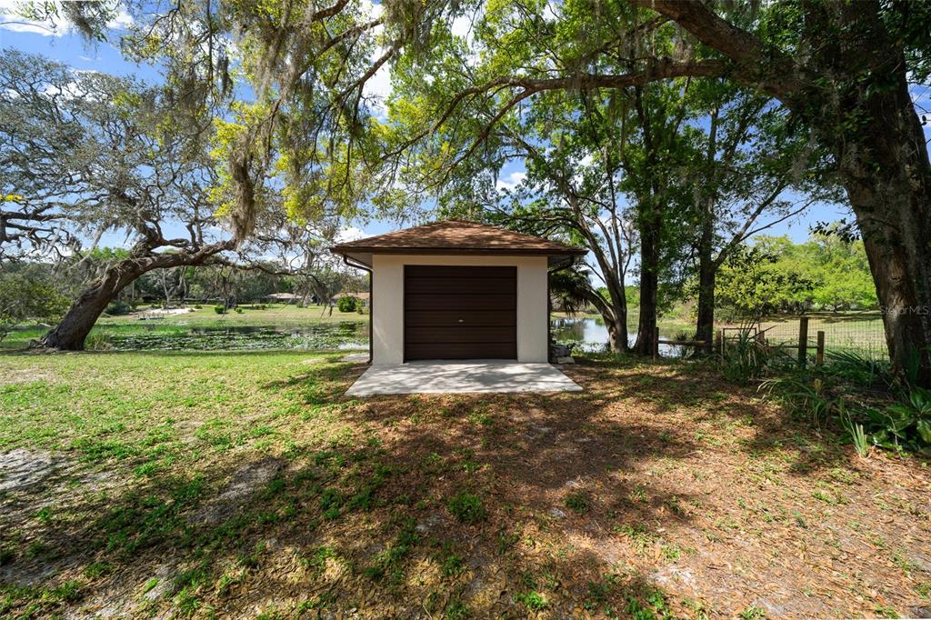 9923 East St Regis Court Inverness, FL 34450 - Photo 27 of 76 a front view of a house with a yard and garage