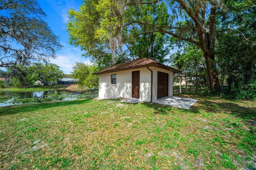 9923 East St Regis Court Inverness, FL 34450 - Photo 28 of 76 a view of a house with a yard and large tree