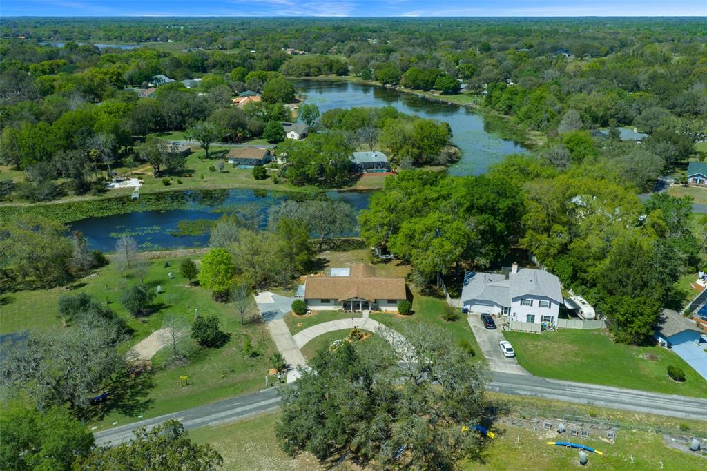 9923 East St Regis Court Inverness, FL 34450 - Photo 3 of 76 an aerial view of residential houses with outdoor space and trees
