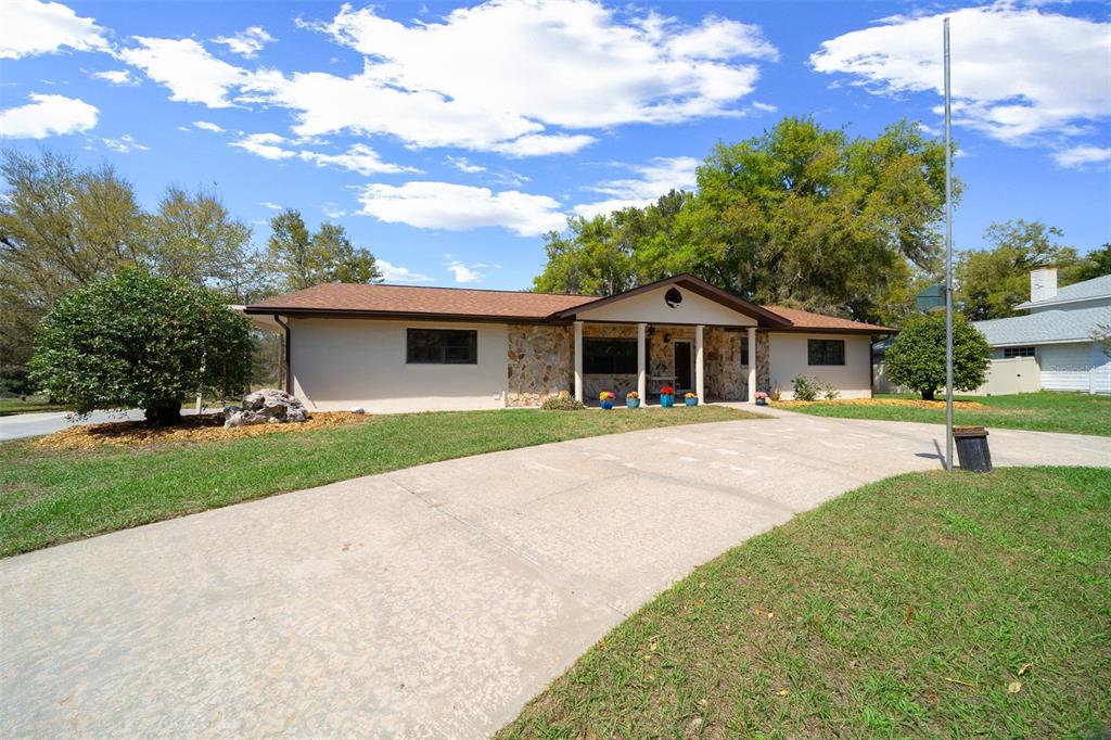 9923 East St Regis Court Inverness, FL 34450 - Photo 36 of 76 a front view of a house with a garden