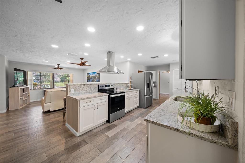 9923 East St Regis Court Inverness, FL 34450 - Photo 46 of 76 a kitchen with sink and stove top oven