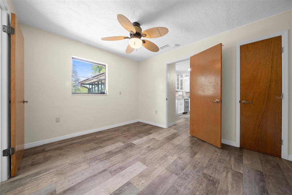 9923 East St Regis Court Inverness, FL 34450 - Photo 53 of 76 a view of an empty room with wooden floor and a ceiling fan