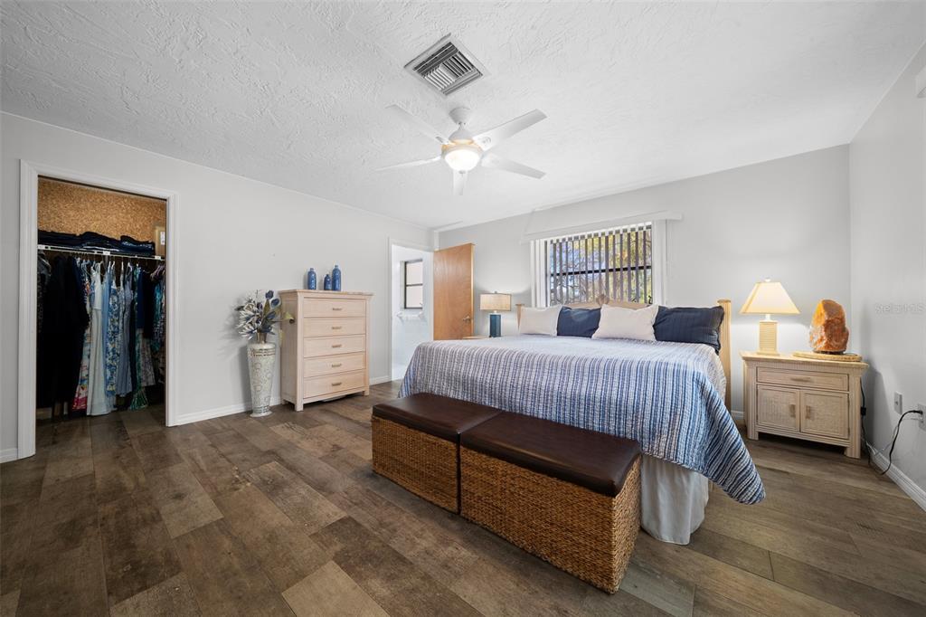9923 East St Regis Court Inverness, FL 34450 - Photo 71 of 76 a spacious bedroom with a bed and a walk in closet