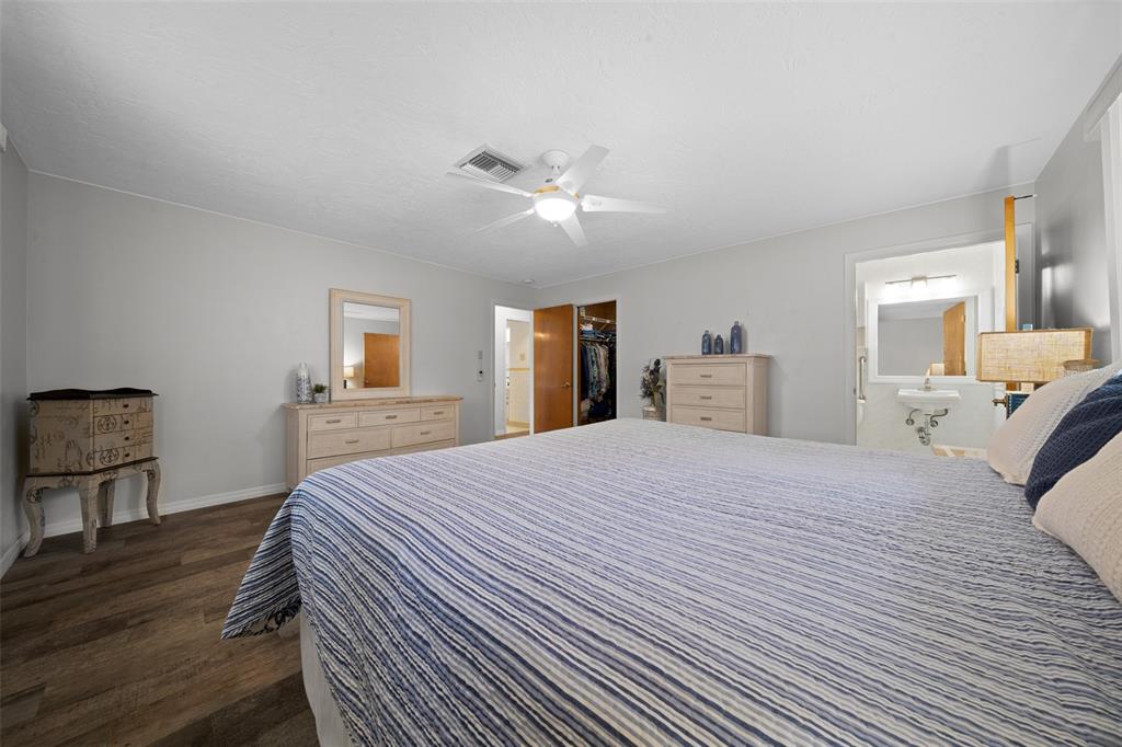 9923 East St Regis Court Inverness, FL 34450 - Photo 72 of 76 a bedroom with a large bed and wooden floor
