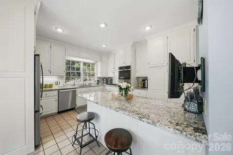 a kitchen with sink cabinets and refrigerator
