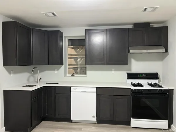a kitchen with stainless steel appliances granite countertop a sink and a stove