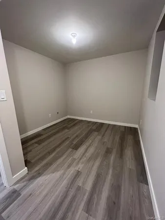 a view of room with wooden floor